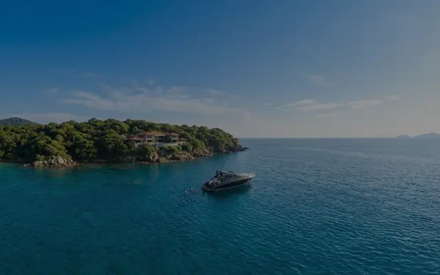 Luxury boat docked near a serene coastline. Human images in this ad were created using AI.